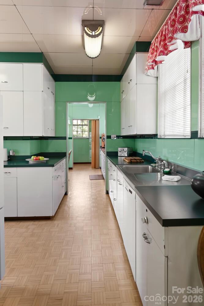 407 Vanderbilt Road Asheville, NC 28803 - Photo 23 of 48 a kitchen with stainless steel appliances a sink a counter top space cabinets and a window