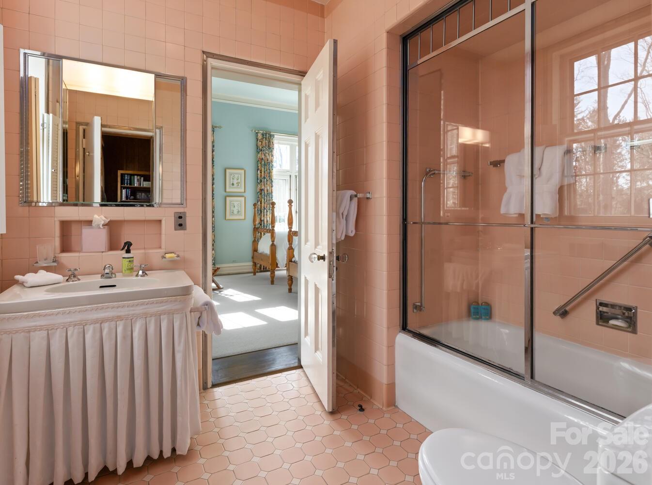 407 Vanderbilt Road Asheville, NC 28803 - Photo 28 of 48 a bathroom with a tub a mirror and a shower