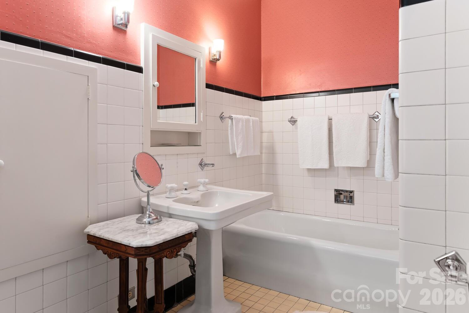407 Vanderbilt Road Asheville, NC 28803 - Photo 39 of 48 a bathroom with a sink a bathtub and a shower