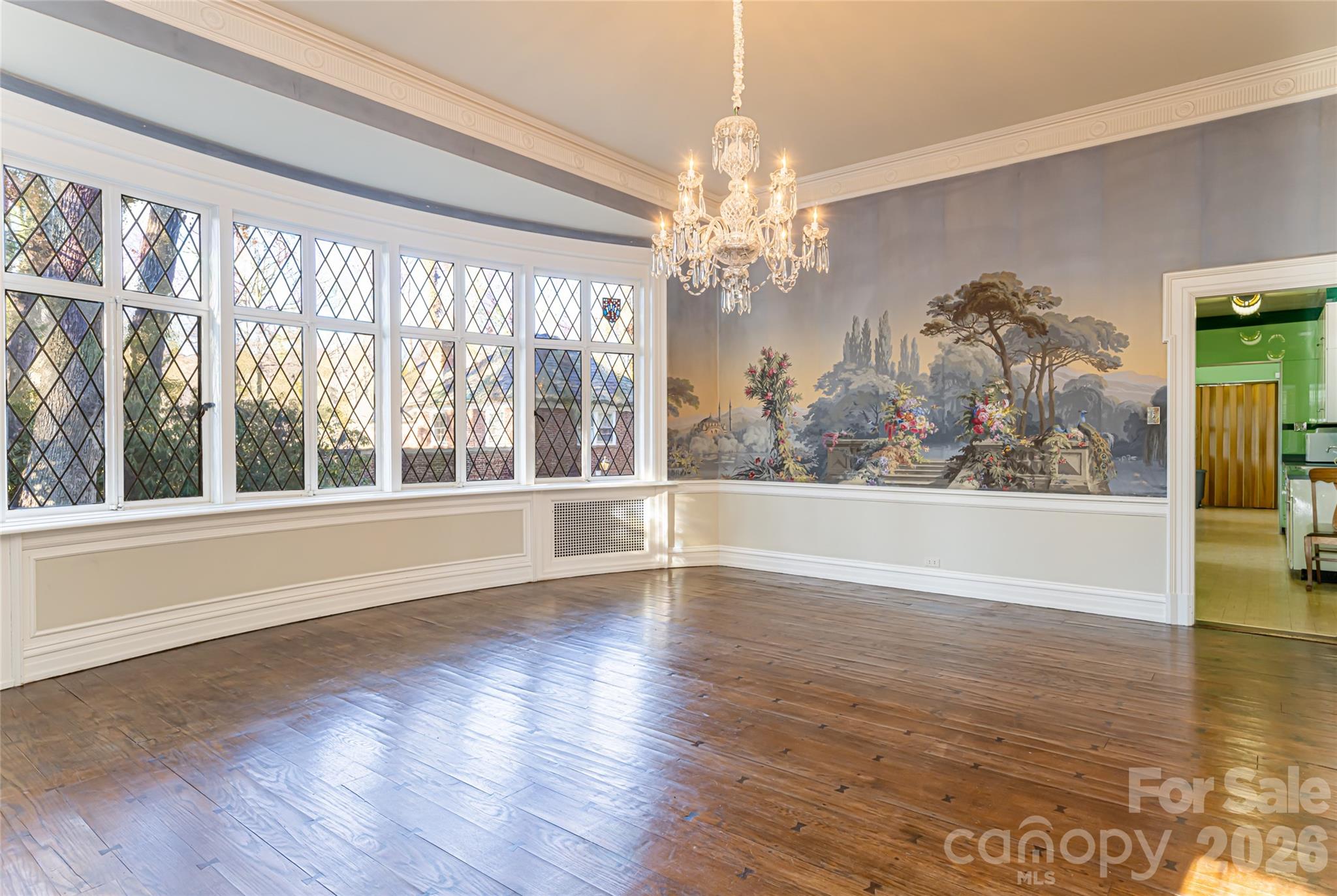 407 Vanderbilt Road Asheville, NC 28803 - Photo 10 of 48 a view of a room with wooden floor chandelier and a window