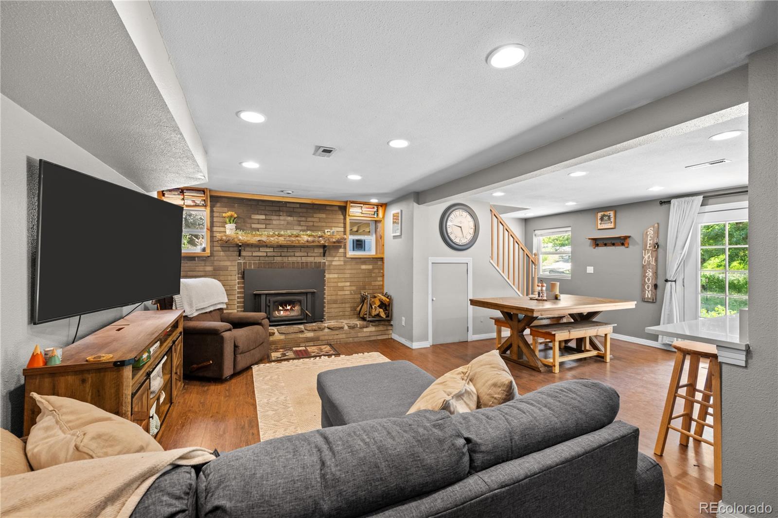 5211 Parmalee Gulch Road Indian Hills, CO 80454 - Photo 12 of 43 a living room with furniture and a flat screen tv