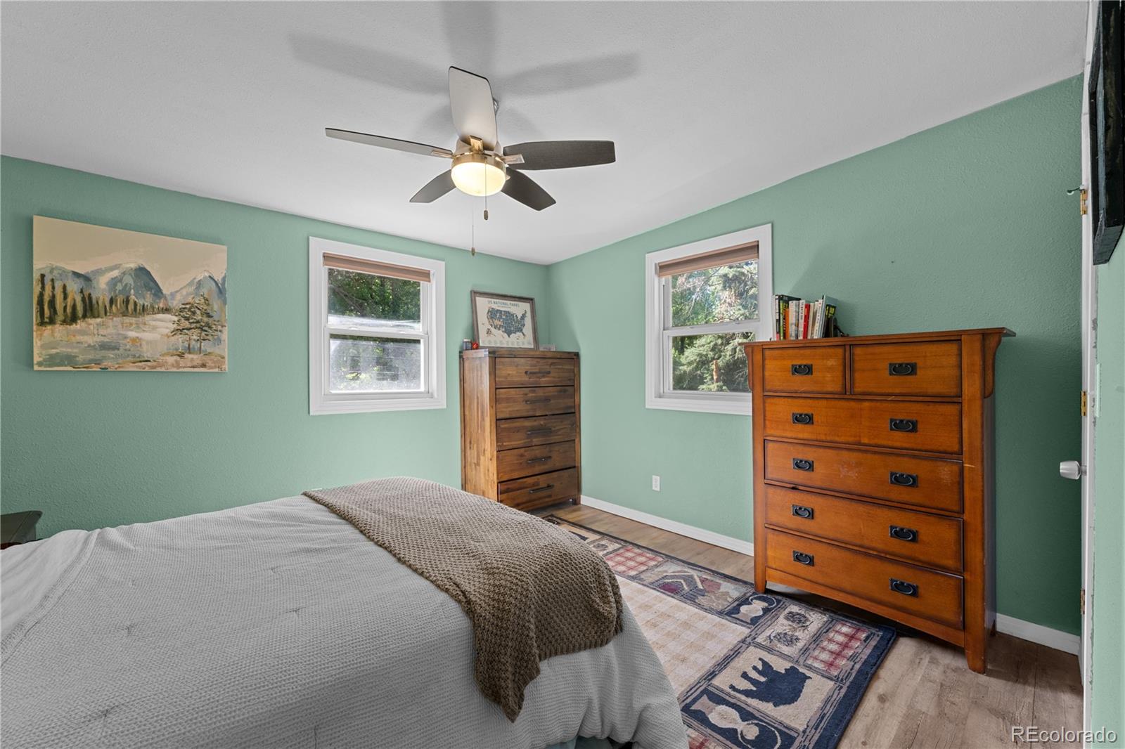 5211 Parmalee Gulch Road Indian Hills, CO 80454 - Photo 17 of 43 a bedroom with a bed dresser and a window