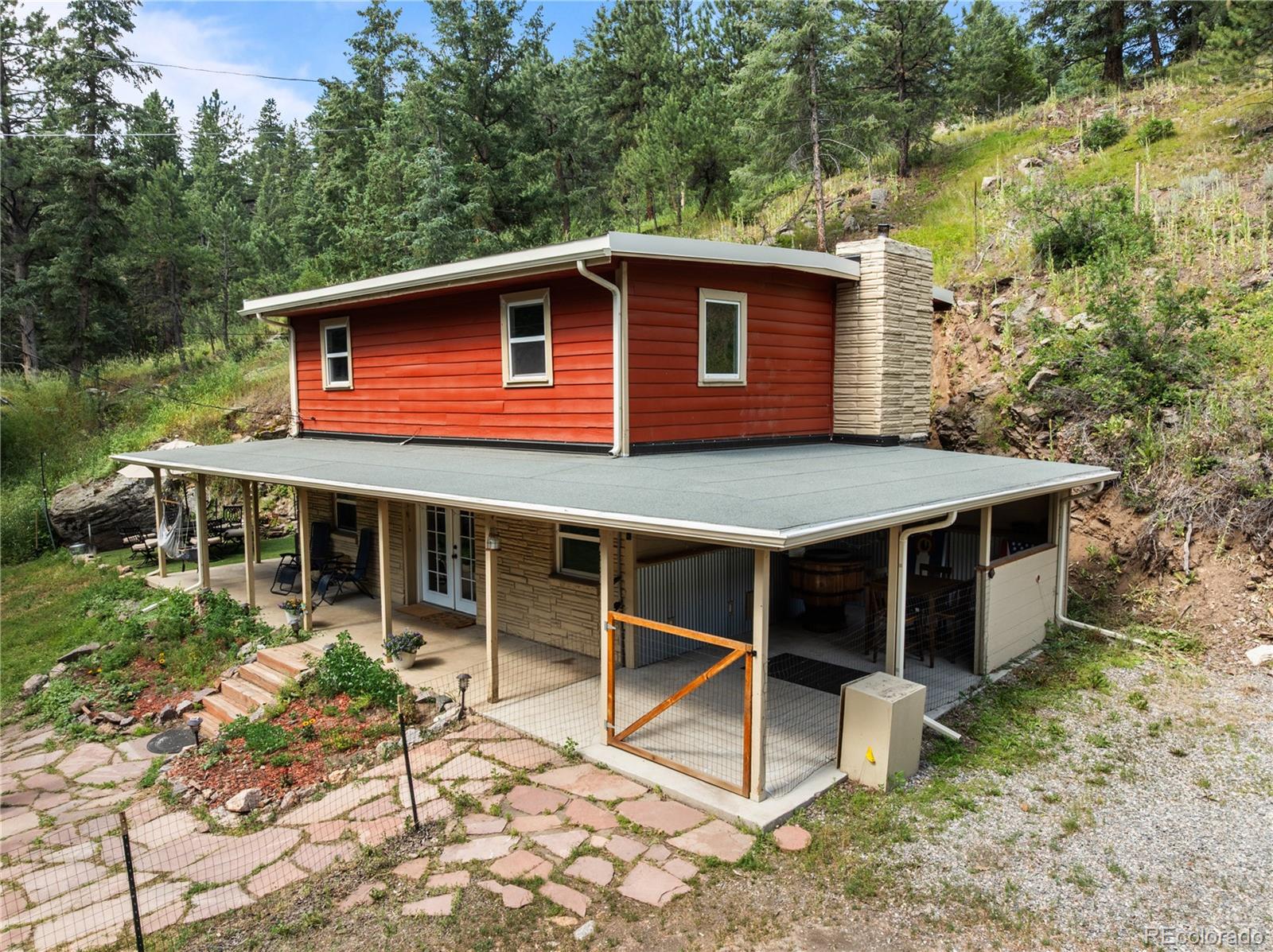 5211 Parmalee Gulch Road Indian Hills, CO 80454 - Photo 2 of 43 a view of a house with a backyard
