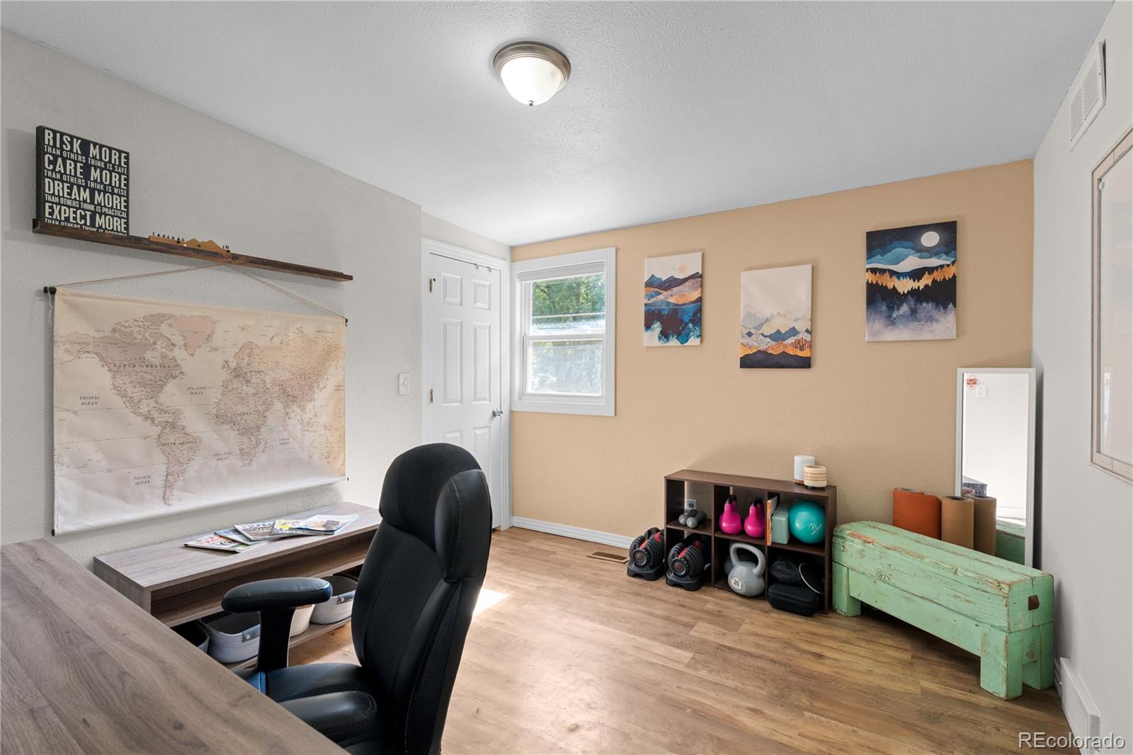 5211 Parmalee Gulch Road Indian Hills, CO 80454 - Photo 21 of 43 a living room with furniture and a wooden floor