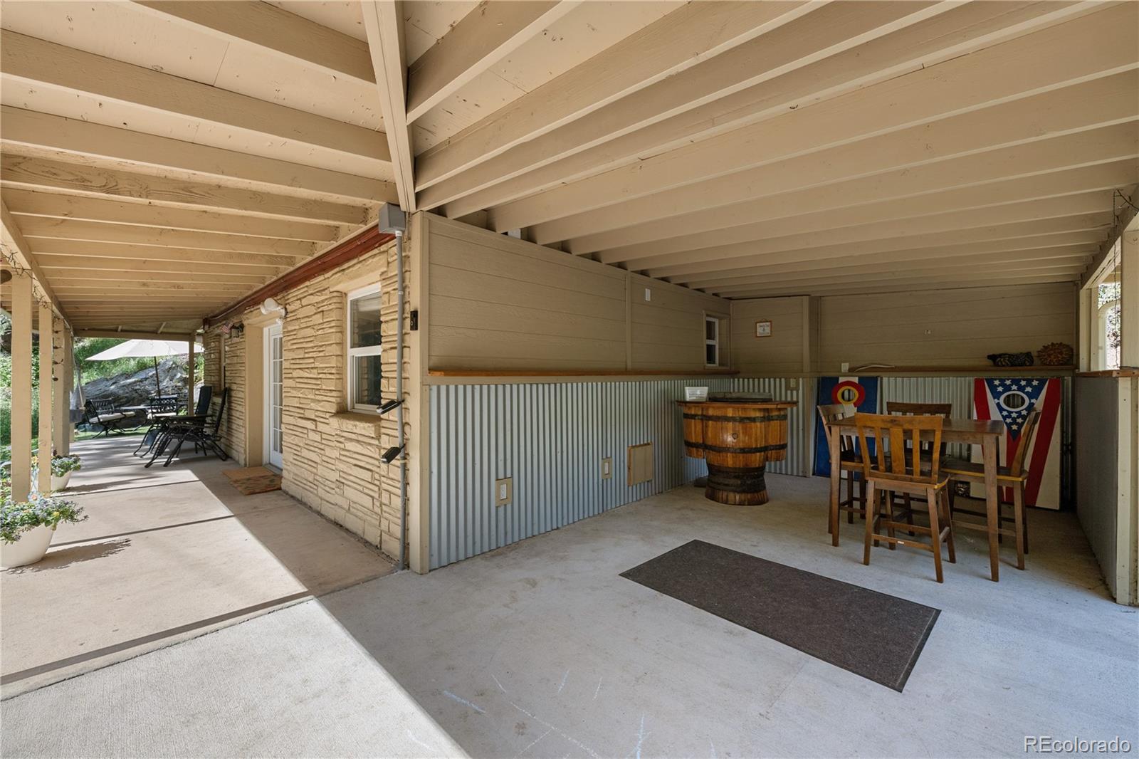 5211 Parmalee Gulch Road Indian Hills, CO 80454 - Photo 22 of 43 a view of a garage with furniture