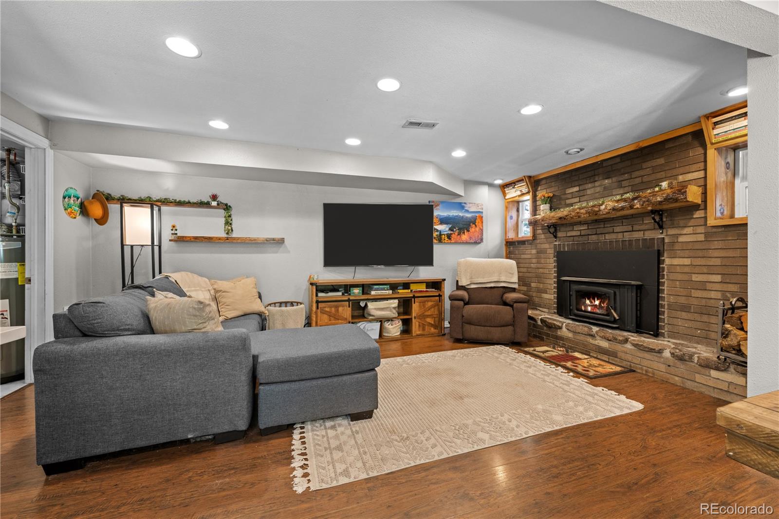 5211 Parmalee Gulch Road Indian Hills, CO 80454 - Photo 10 of 43 a living room with furniture and a flat screen tv