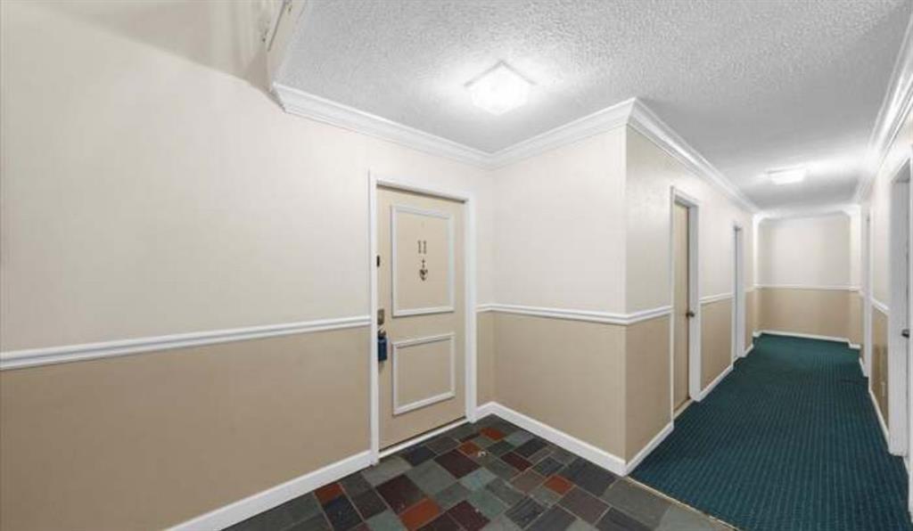 6851 Roswell Road, Unit I15 Atlanta, GA 30328 - Photo 11 of 29 a view of hallway with stairs and wooden floor