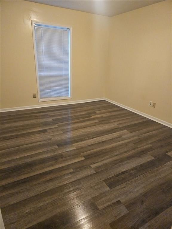 6851 Roswell Road, Unit I15 Atlanta, GA 30328 - Photo 14 of 29 a view of an empty room with wooden floor and a window