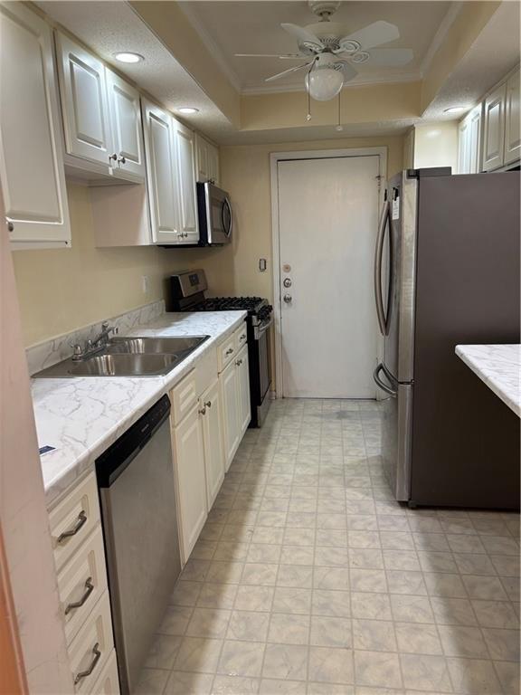 6851 Roswell Road, Unit I15 Atlanta, GA 30328 - Photo 17 of 29 a kitchen with a sink a refrigerator and cabinets