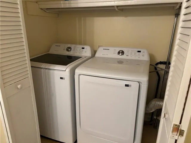 a view of a house with wooden fence