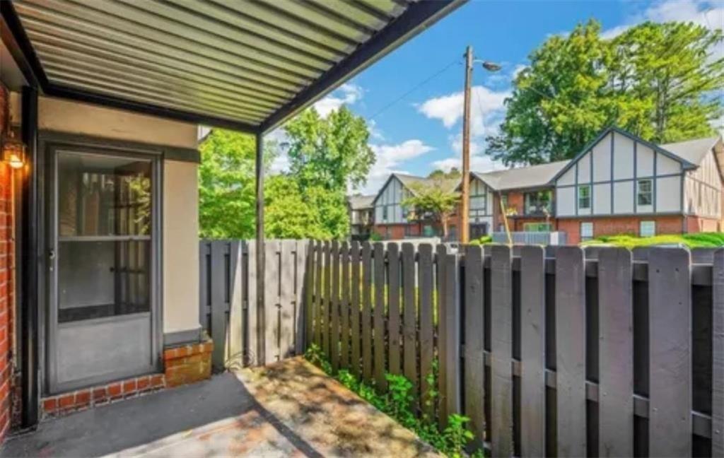 6851 Roswell Road, Unit I15 Atlanta, GA 30328 - Photo 21 of 29 a view of a house with wooden fence