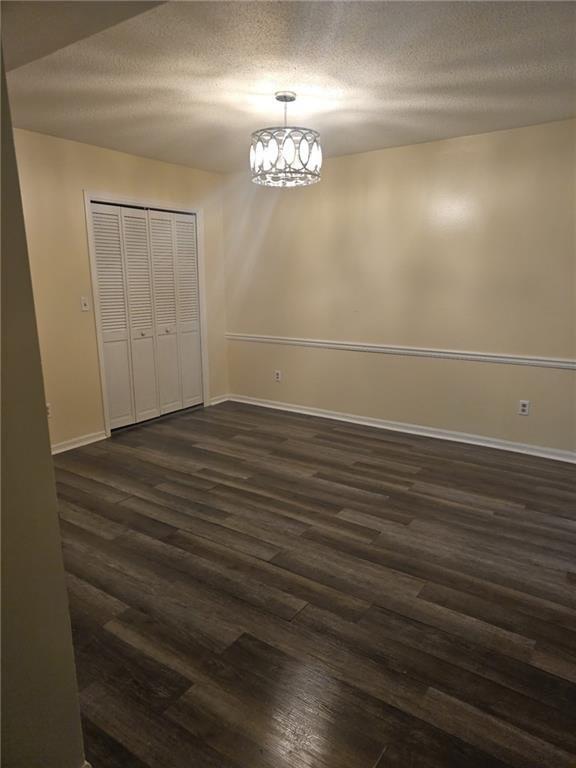 6851 Roswell Road, Unit I15 Atlanta, GA 30328 - Photo 23 of 29 wooden floor in an empty room