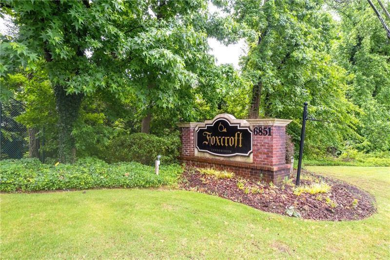 6851 Roswell Road, Unit I15 Atlanta, GA 30328 - Photo 24 of 29 a green field with trees in the background