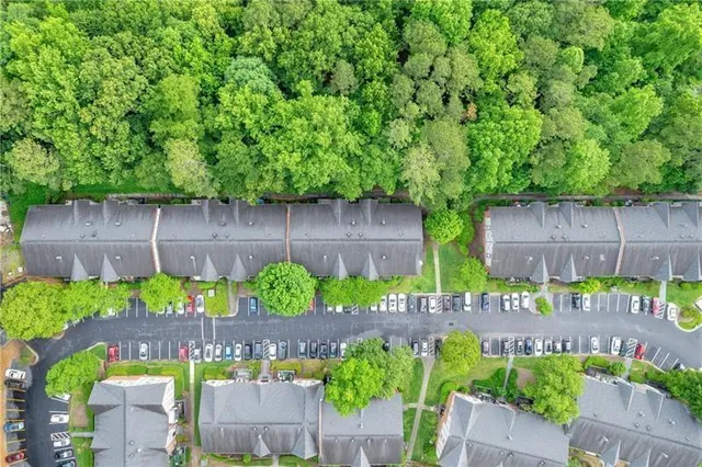 an aerial view of a houses with a green space