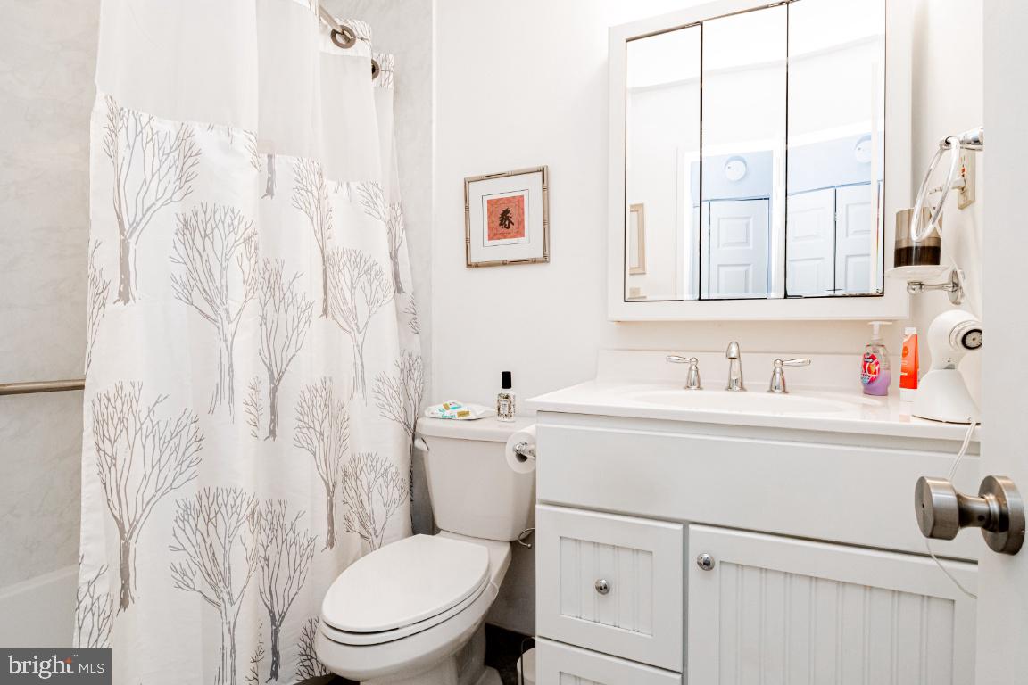 8705 Hayshed Lane, Unit 33 Columbia, MD 21045 - Photo 11 of 22 a bathroom with a sink vanity mirror and toilet