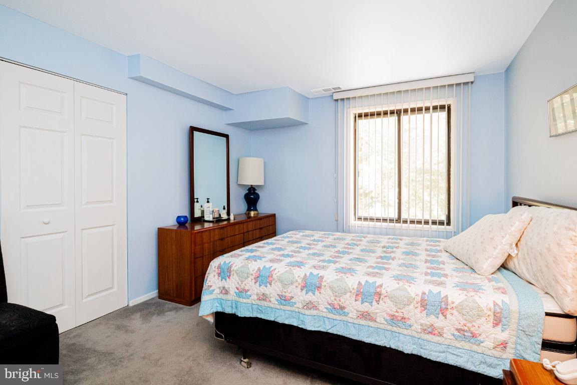 8705 Hayshed Lane, Unit 33 Columbia, MD 21045 - Photo 13 of 22 a bedroom with a bed and a window