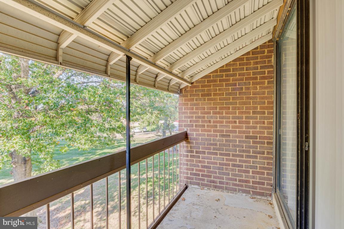 8705 Hayshed Lane, Unit 33 Columbia, MD 21045 - Photo 19 of 22 a view of a porch with a table and chairs