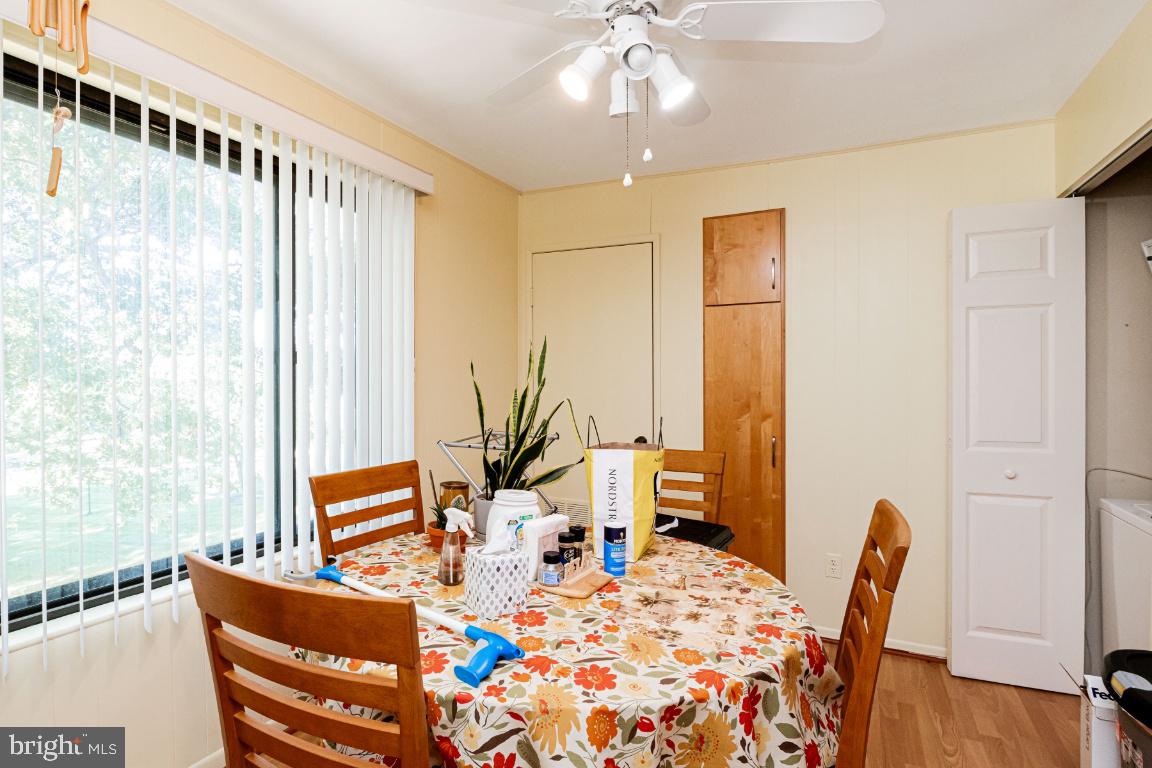 8705 Hayshed Lane, Unit 33 Columbia, MD 21045 - Photo 6 of 22 a view of a dining room with furniture and wooden floor