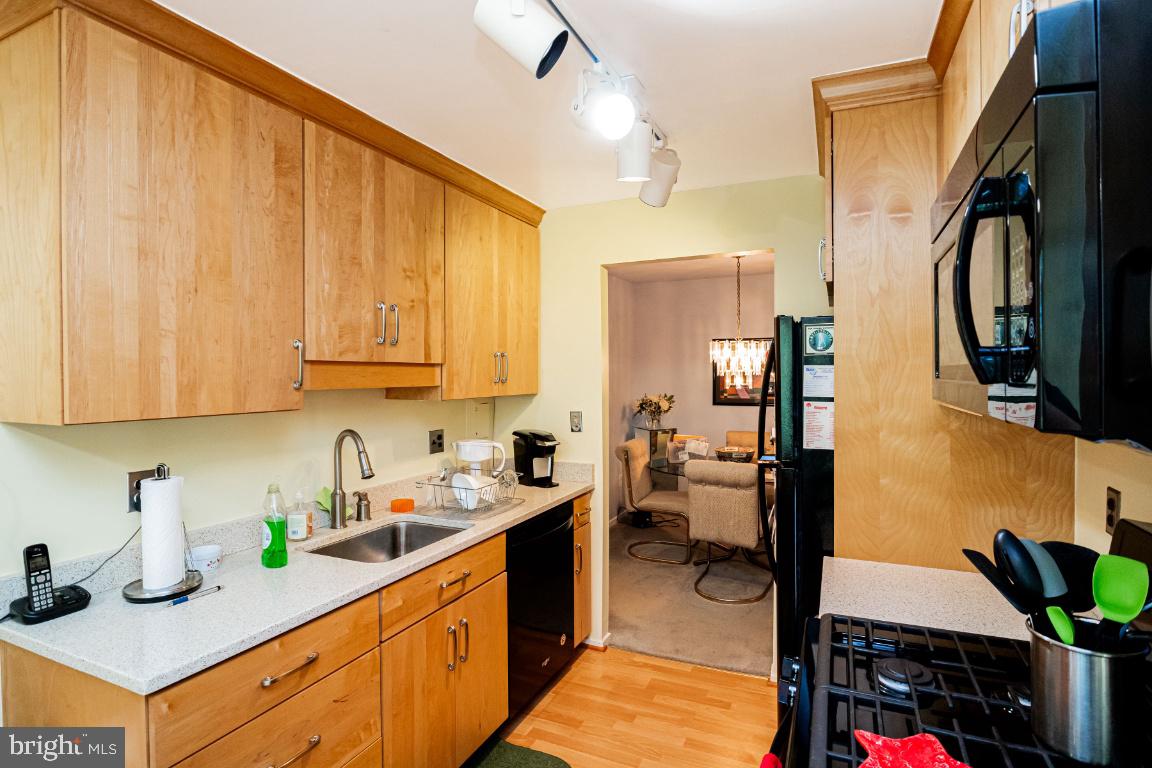 8705 Hayshed Lane, Unit 33 Columbia, MD 21045 - Photo 8 of 22 a kitchen with a sink a stove and cabinets