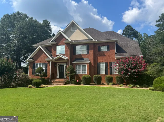 a front view of a house with a yard