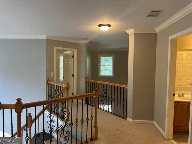 a view of a hallway with windows and stairs