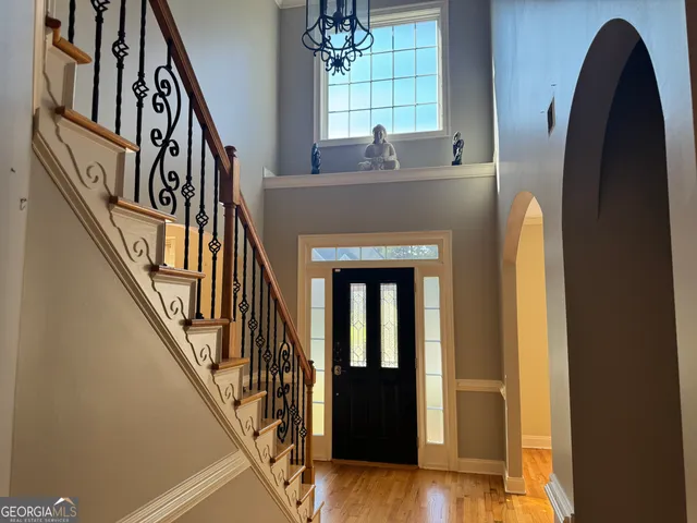 a view of staircase with a large window and wooden floor