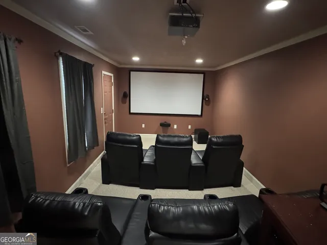 a living room with furniture and a projector screen