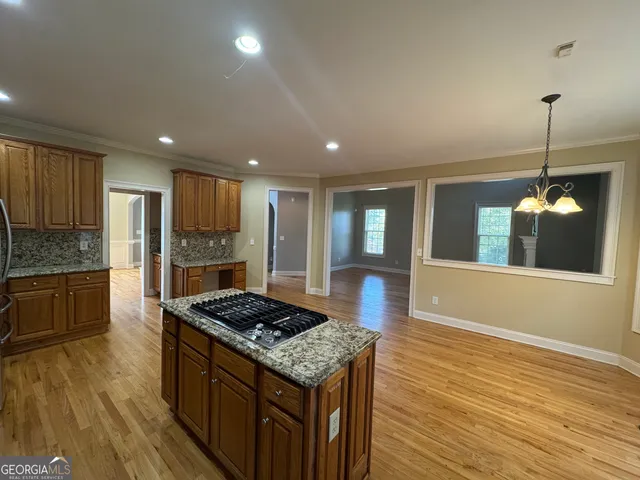 a kitchen with a stove and white cabinets