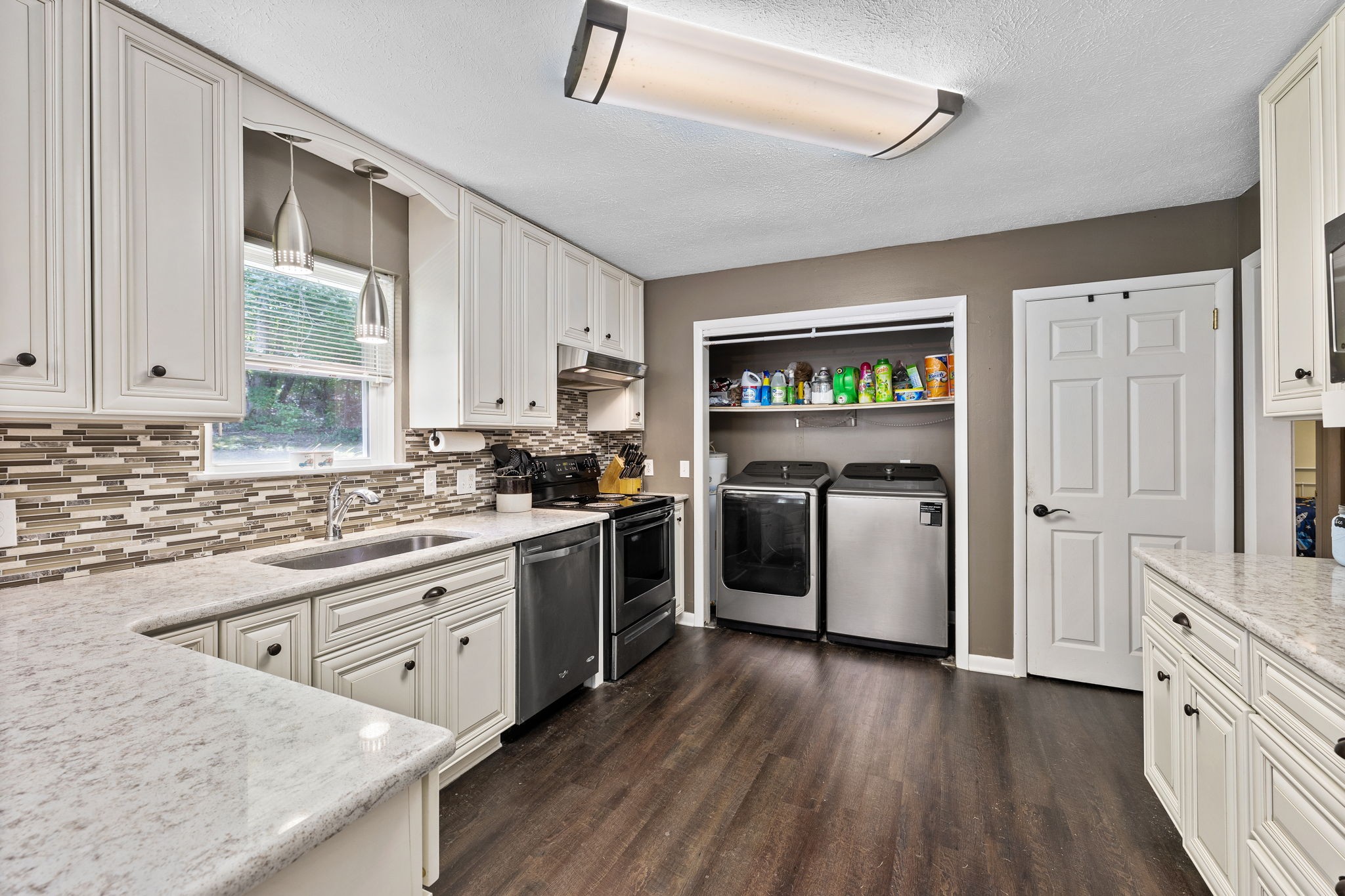 1165 Manley Loop Dickson, TN 37055 - Photo 11 of 29 a kitchen with stainless steel appliances granite countertop a stove a sink dishwasher and a refrigerator