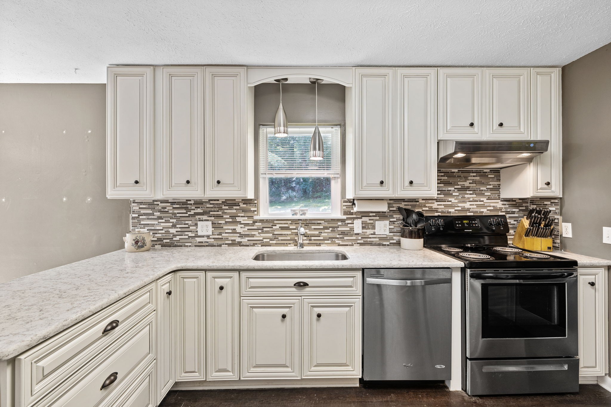 1165 Manley Loop Dickson, TN 37055 - Photo 12 of 29 a kitchen with granite countertop white cabinets and stainless steel appliances