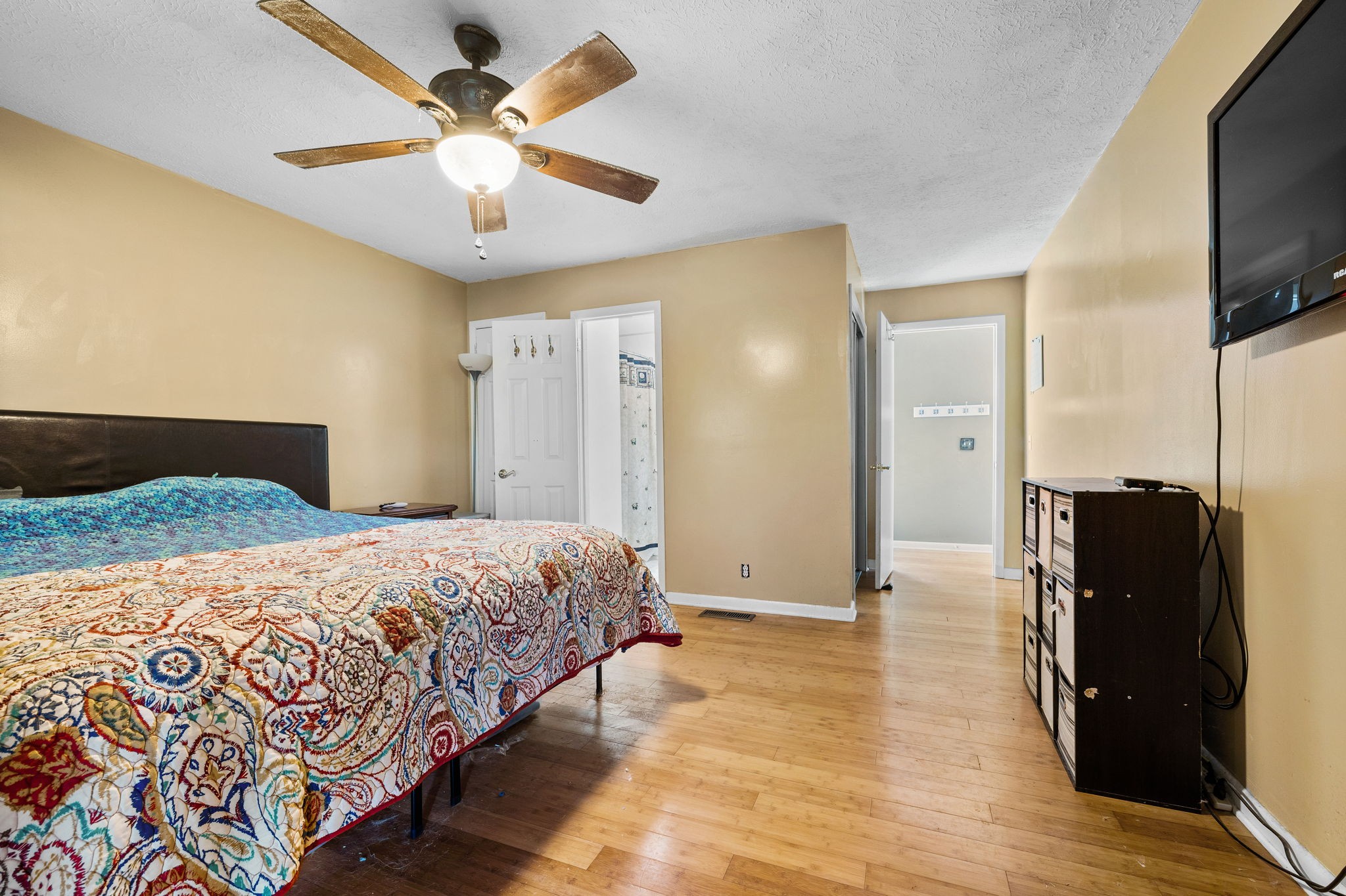 1165 Manley Loop Dickson, TN 37055 - Photo 14 of 29 a bedroom with a bed and a flat screen tv