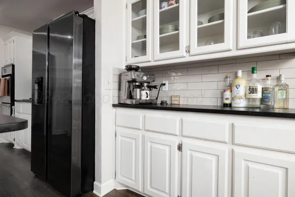 a kitchen with stainless steel appliances granite countertop a refrigerator and a cabinets