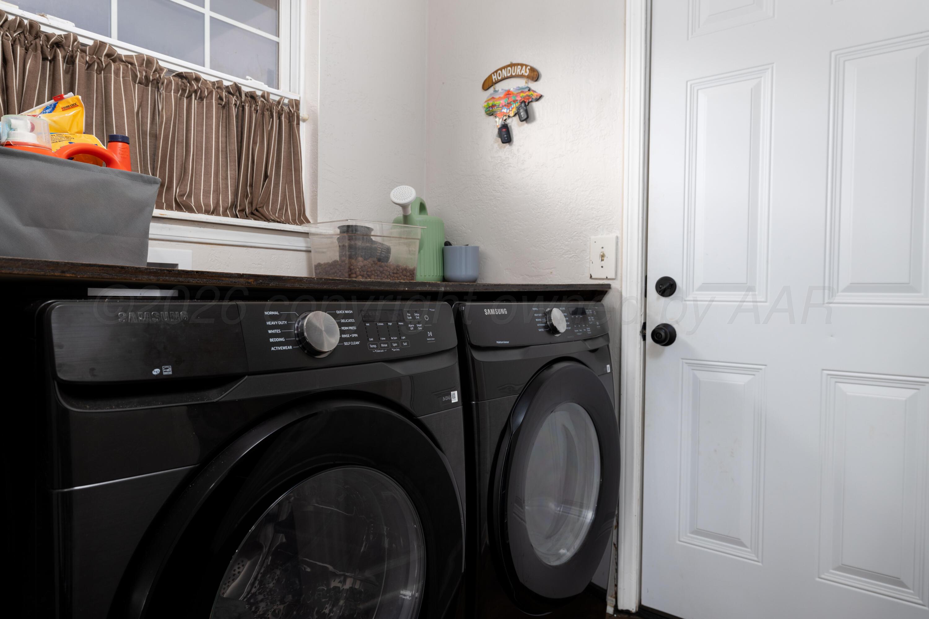 3509 Timber Drive Amarillo, TX 79121 - Photo 16 of 35 a utility room with dryer and washer