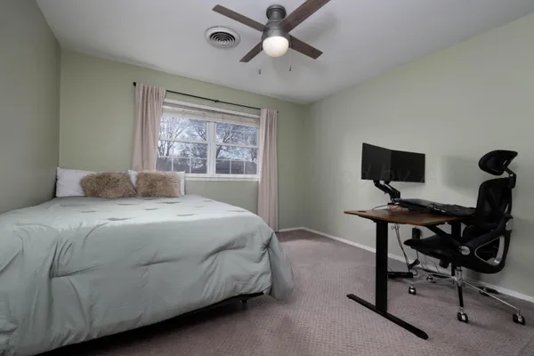 a bedroom with a bed and a desk