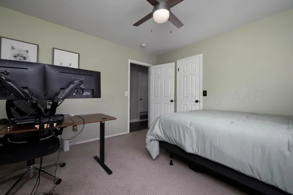 a bed room with a bed window and a chair