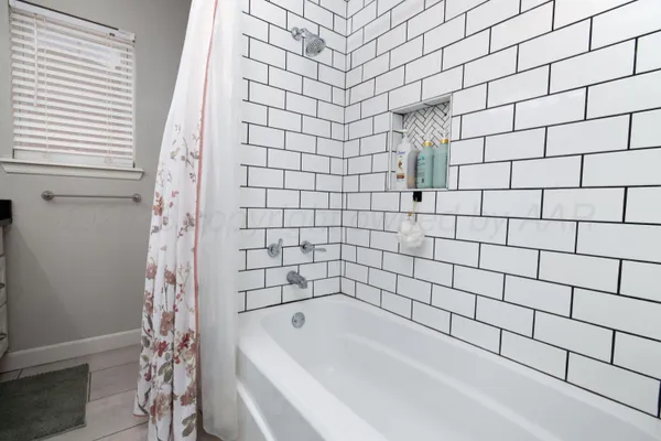 a bathroom with a bathtub and shower