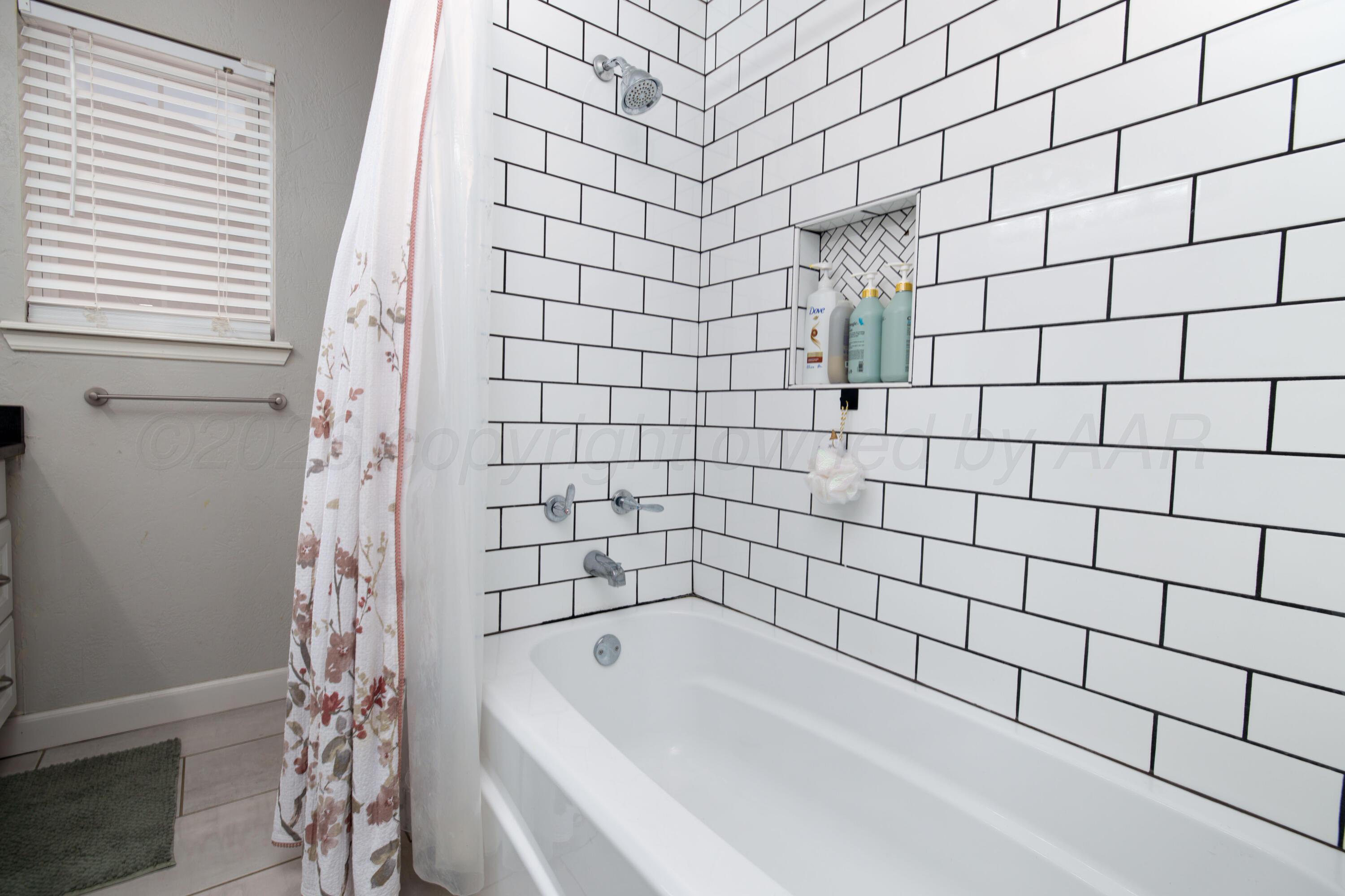 3509 Timber Drive Amarillo, TX 79121 - Photo 24 of 35 a bathroom with a bathtub and shower