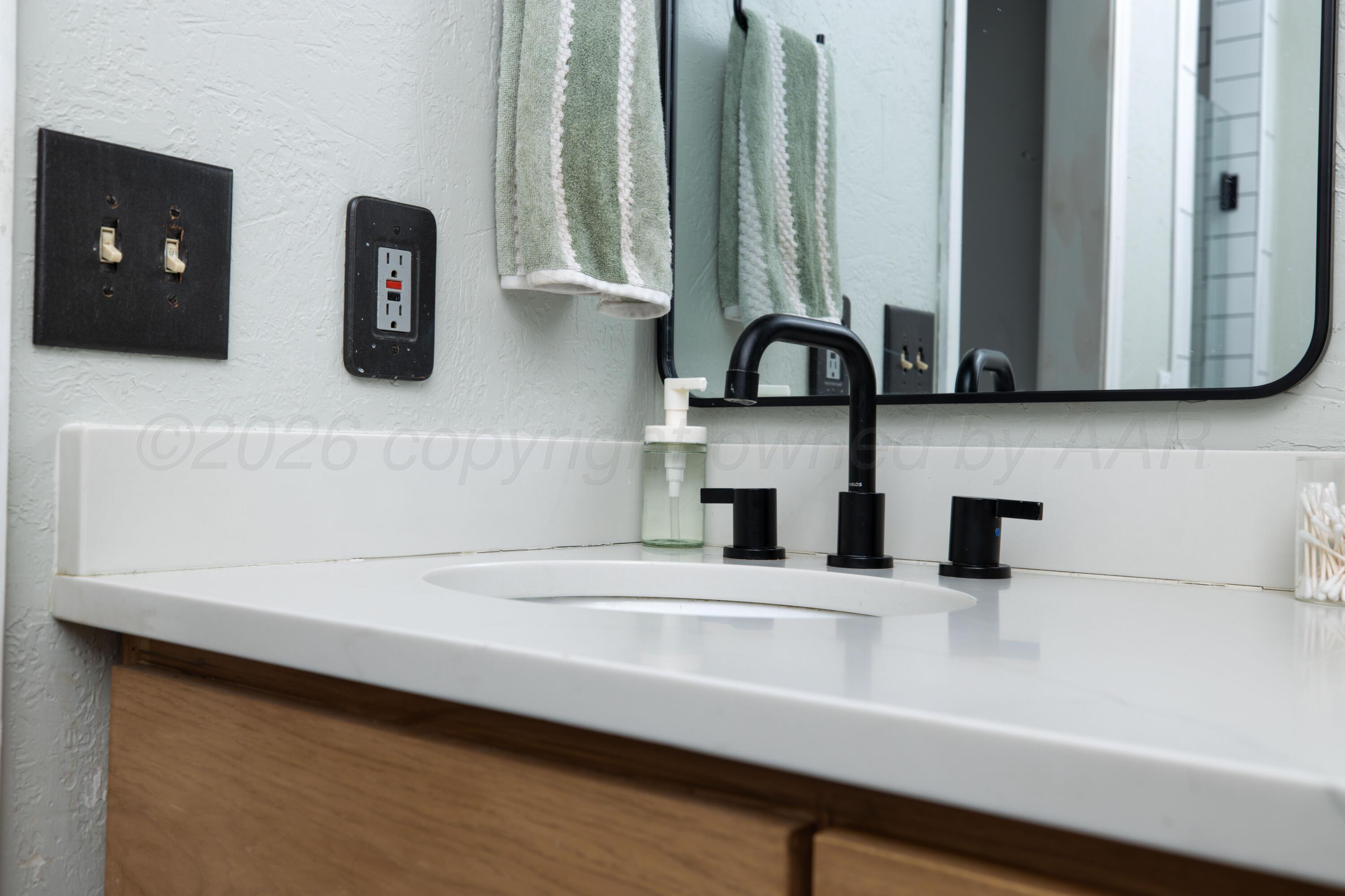 3509 Timber Drive Amarillo, TX 79121 - Photo 28 of 35 a kitchen with a sink and a mirror