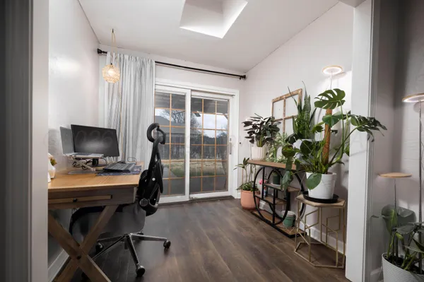 a view of a workspace with furniture and a potted plant
