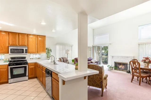 a kitchen with granite countertop a stove and a refrigerator