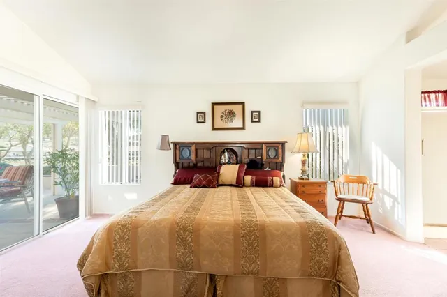 a bedroom with a large bed and a large window