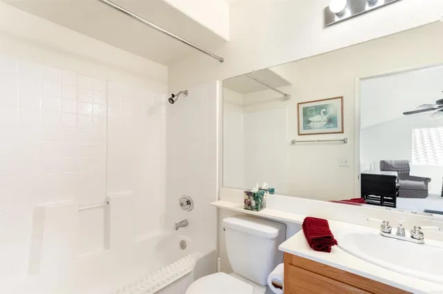 a bathroom with a sink mirror vanity and toilet