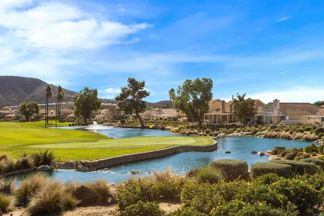 a view of a lake with houses in the back