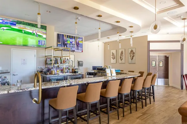 a dining table with chairs and view kitchen