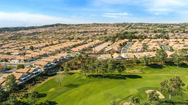 an aerial view of residential houses with outdoor space