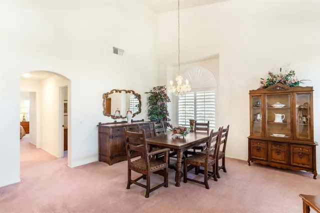 a view of a dining room with furniture and window