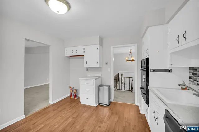 a room with a bed and a view of living room