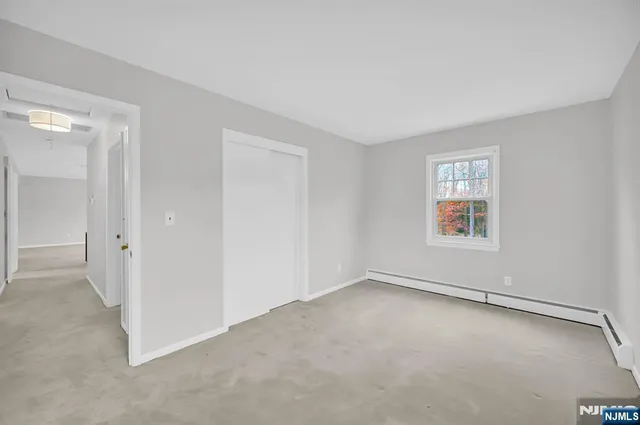 an empty room with a empty space and windows