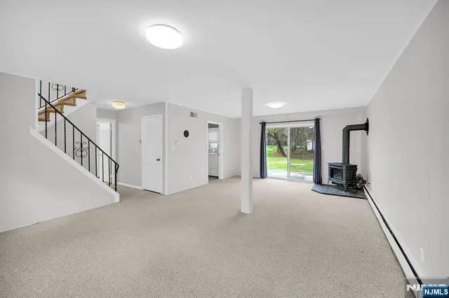 a view of a livingroom with wooden floor and stairs