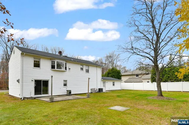 a view of a white house with a yard